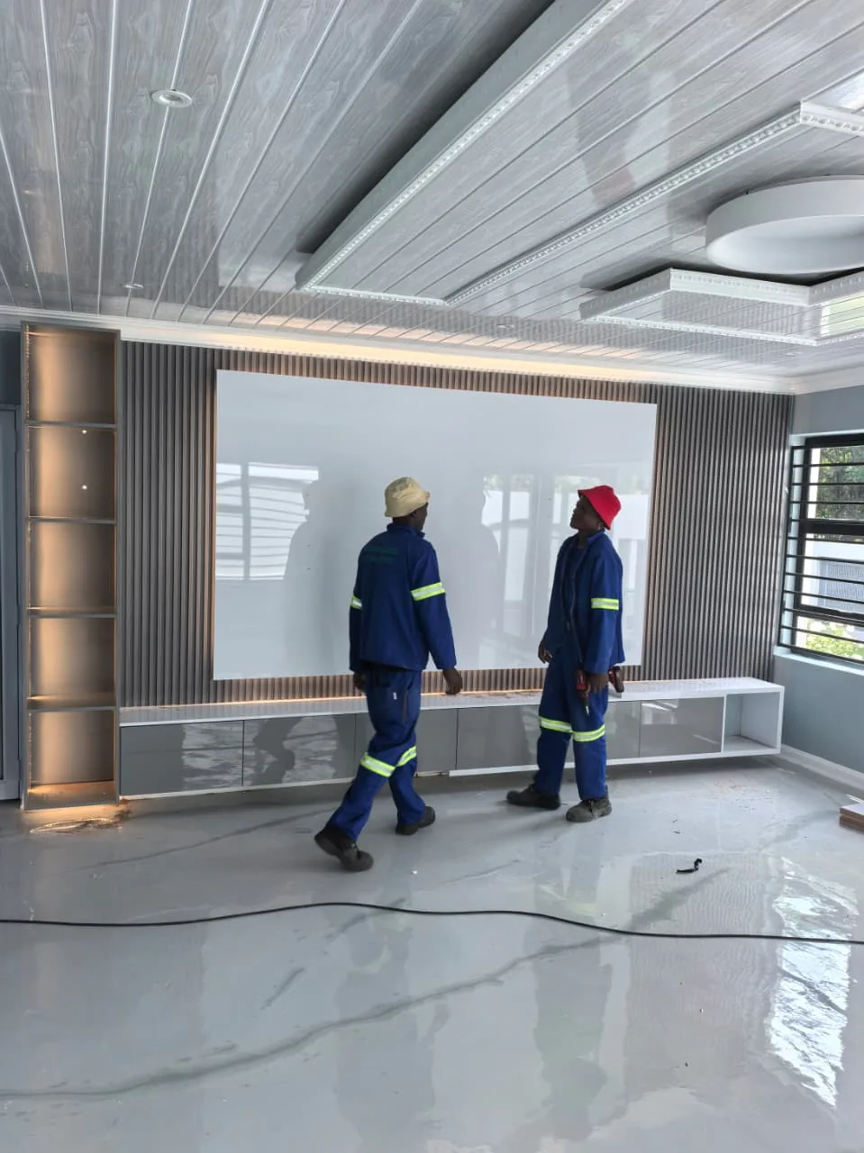 Nimrod Renovations team completing a custom TV feature wall